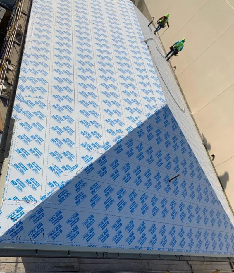 Professional roofers installing underlayment on a metal roof in Black Mountain